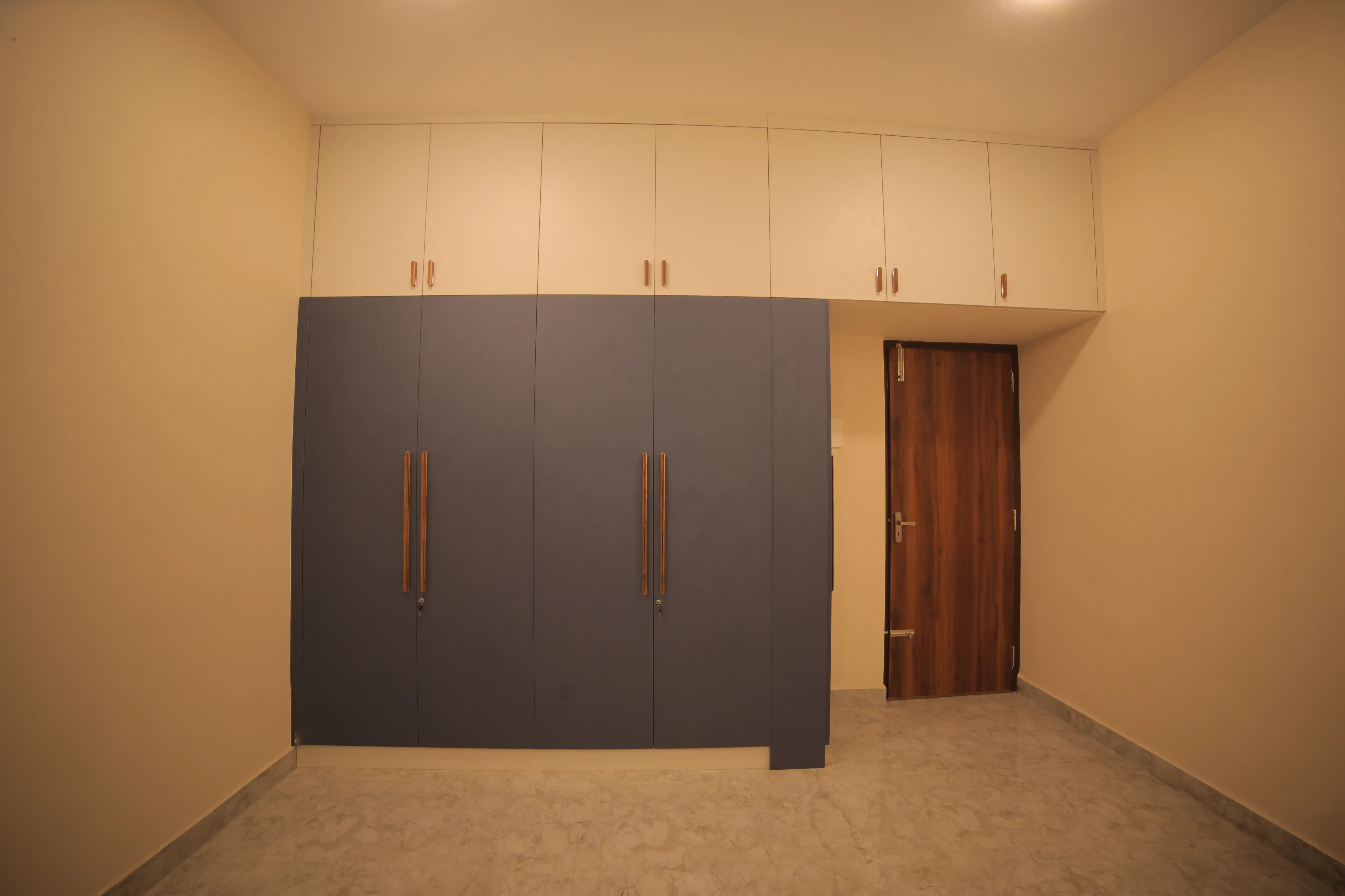 Bedroom design with warm wall and storage finishes